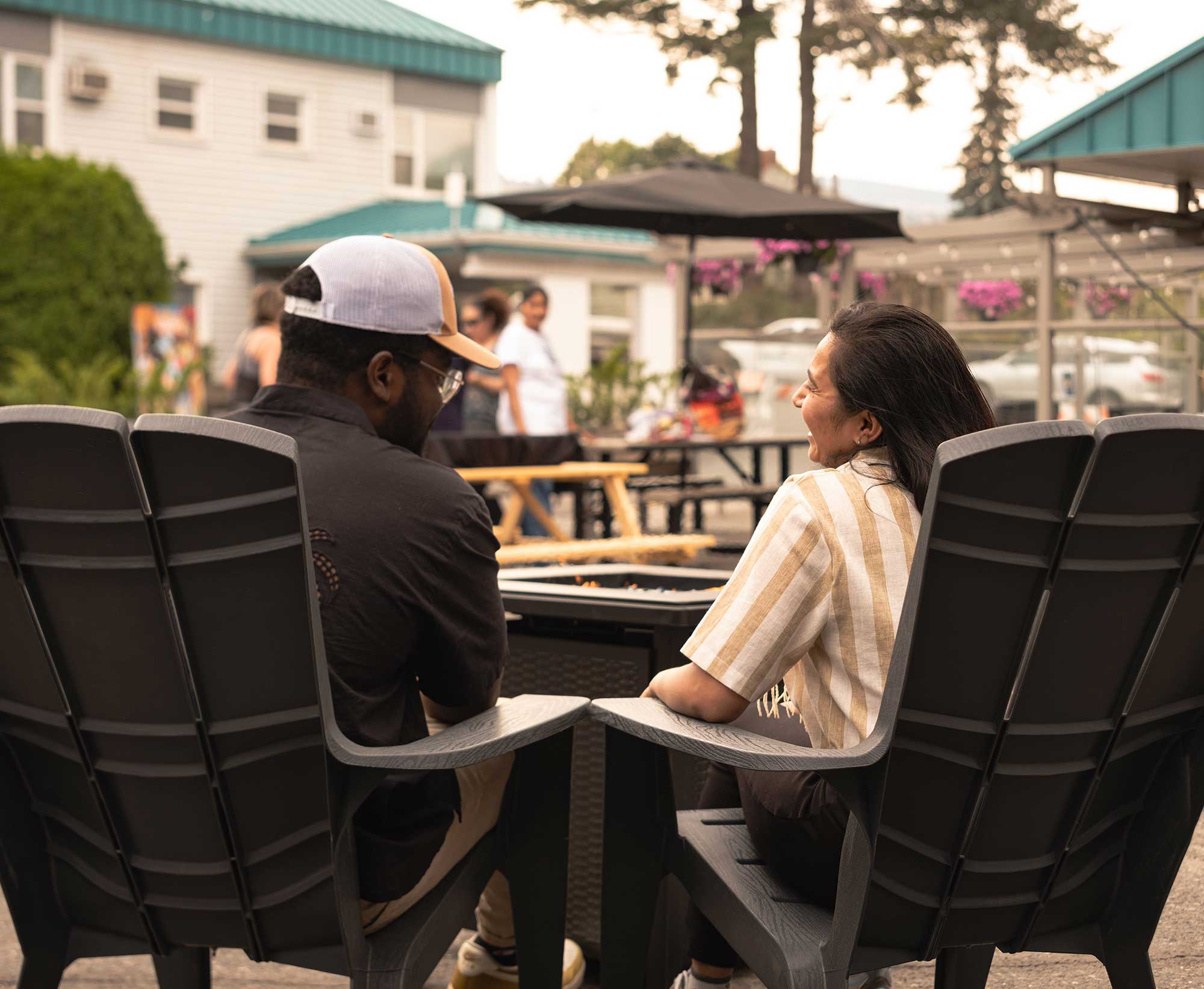 Two people share a laugh on the rooftop patio at Scott's Inn.