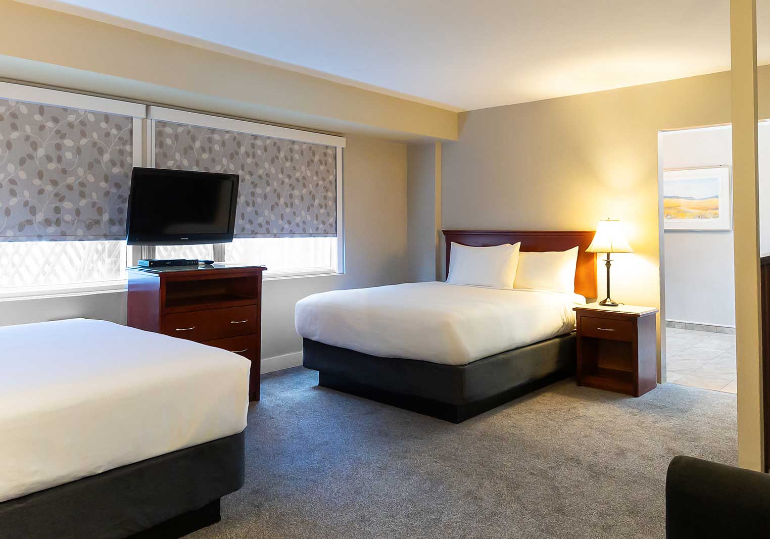 Two beds in the family suite at Scott's Inn, a flat-screened TV between them.