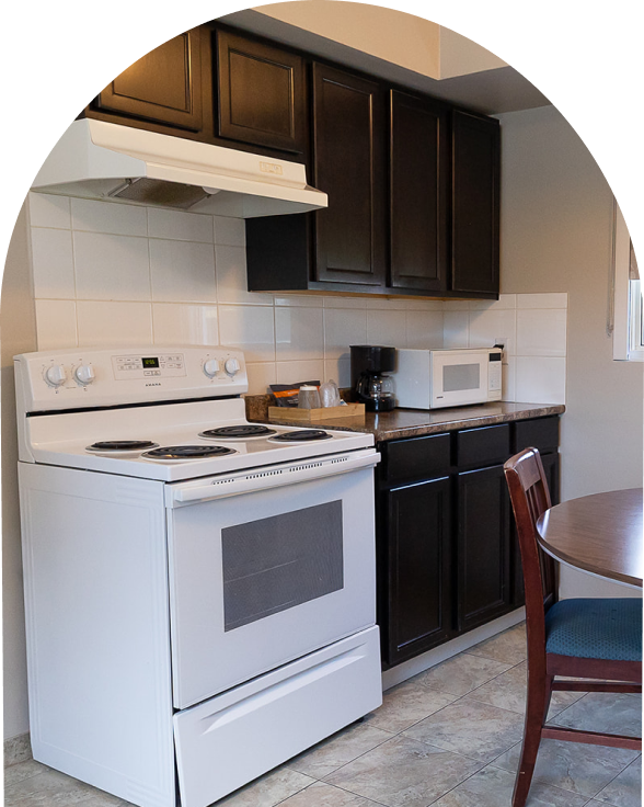 An arch-shaped cropped image of a kitchenette.
