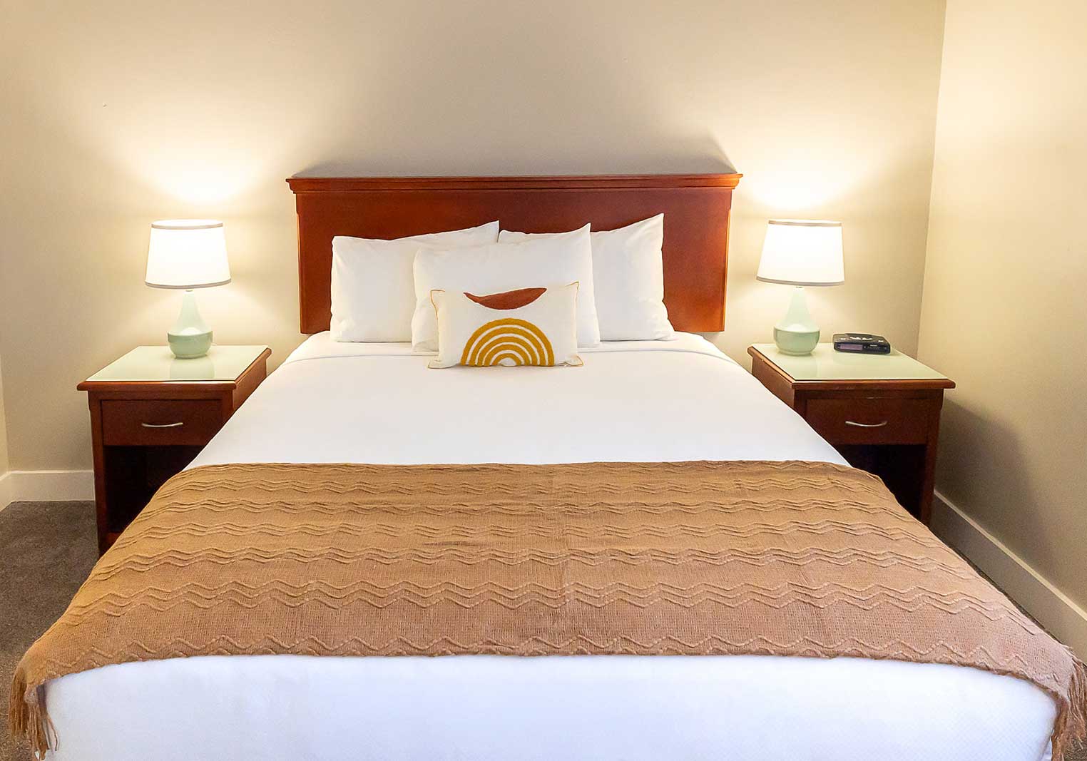 A queen bed in a suite at Scott's Inn.