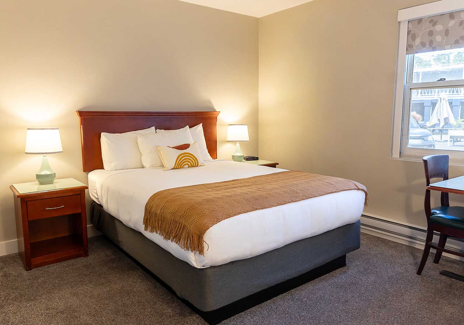 A queen bed in a suite at Scott's Inn.