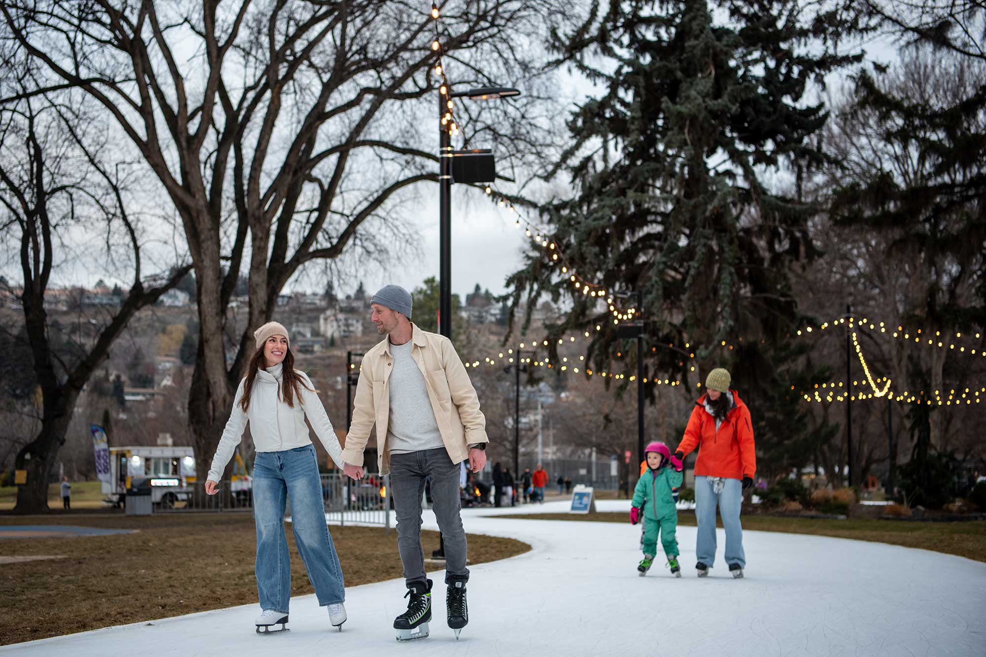 A couple holds hands on the Kamloops riverside skating rink. Photo by Mary Putnam.
